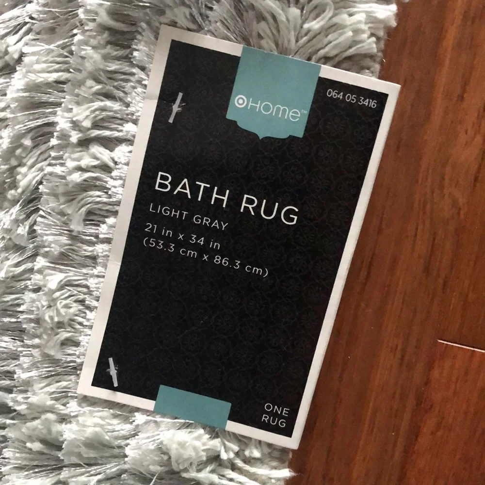 Last chance. Light grey/silver bath rug 1 of 2